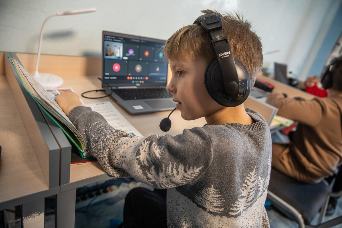 CH1771965_A_schoolboy_reads_in_mathematics_textbook_during_an_online-lesson_in_the_digital_learning_center_in_Kyiv_region,_Ukraine